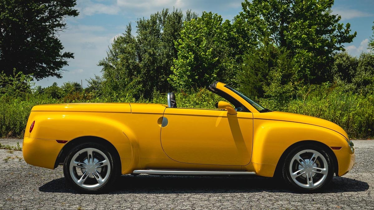 Chevrolet SSR convertible with top down, profile view on road