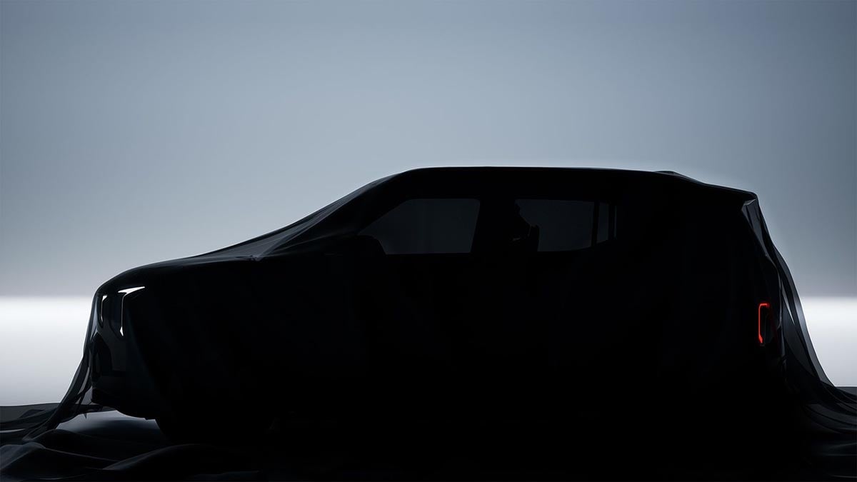 Kia EV2 electric SUV camouflaged under cover in side view with compact B-SUV silhouette