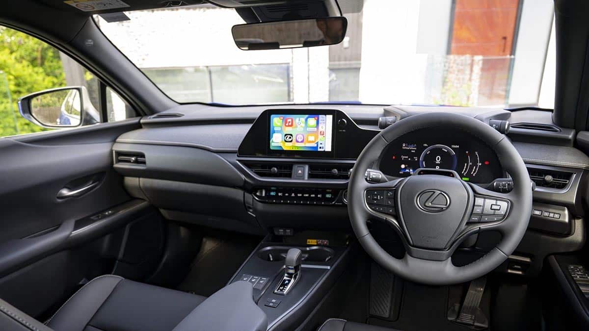 Interior of the 2026 Lexus UX viewed from the driver's seat, central screen and multifunction steering wheel