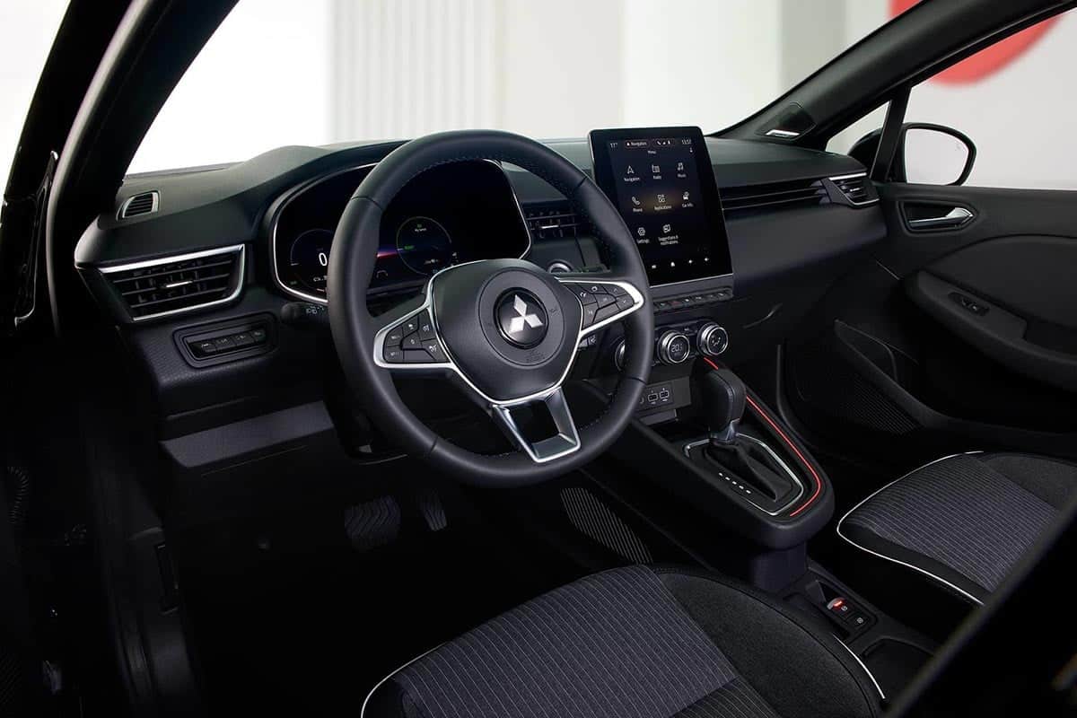 Interior of the 2025 Mitsubishi Colt from the driver's side with touchscreen and multifunction steering wheel