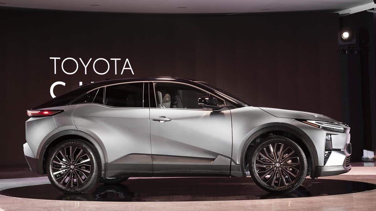 Side profile of the Toyota C-HR+ Electric in midnight blue, coupe silhouette and sloping roofline